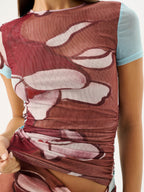 Close-up of a red floral dress with a light blue top underneath