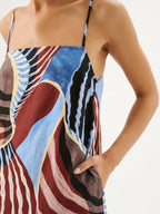Close-up of a colorful dress with abstract patterns on a plain background