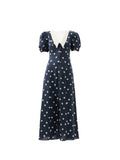 Navy dress with white polka dots on a white background