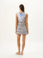 Woman wearing a striped dress with a blue patterned hood on a white background