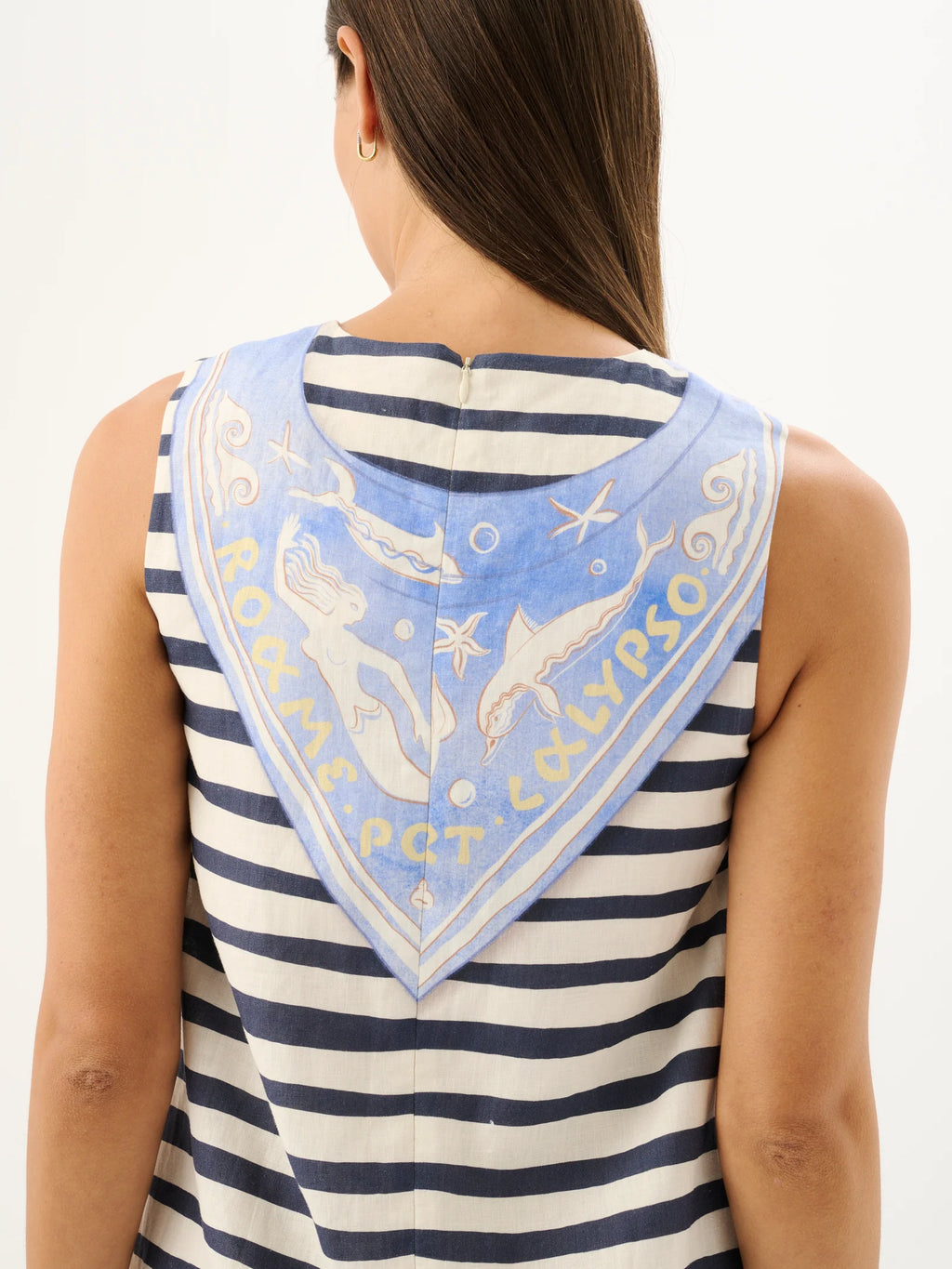 Woman wearing a striped tank top with a decorative bandana on a white background