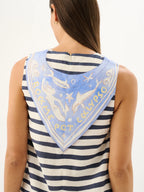 Woman wearing a striped tank top with a decorative bandana on a white background