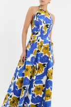 Woman wearing Sabina Maxi Dress Rebecca vallance a blue and yellow floral dress on a white background