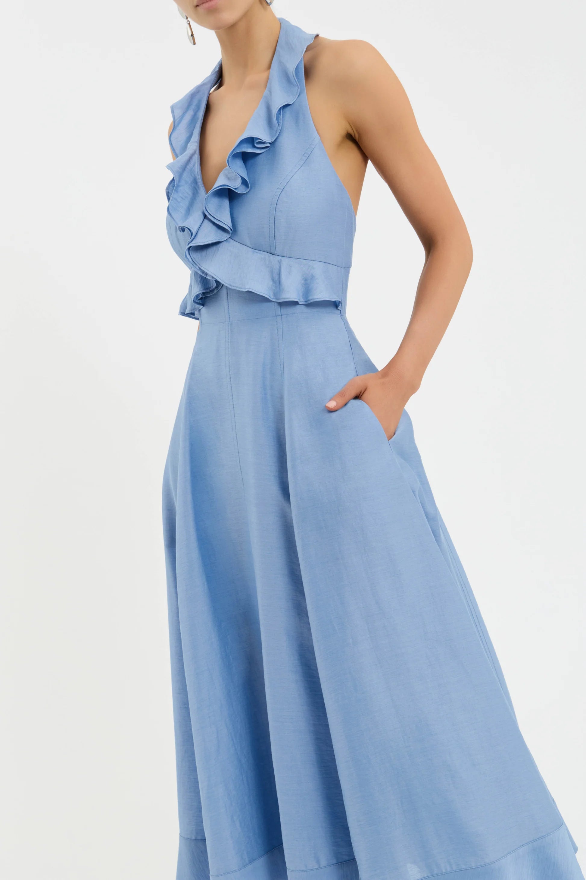 Light blue ruffled jumpsuit on a white background