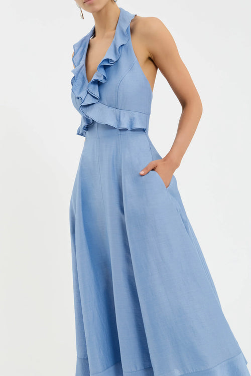 Light blue ruffled jumpsuit on a white background Rebecca Vallance 