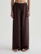Brown wide-leg pants worn by a person on a white background
