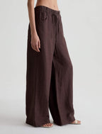 Brown wide-leg pants worn by a person on a white background