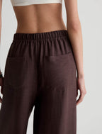 Brown pants worn by a person on a plain background