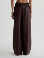 Brown wide-leg pants worn by a person on a white background