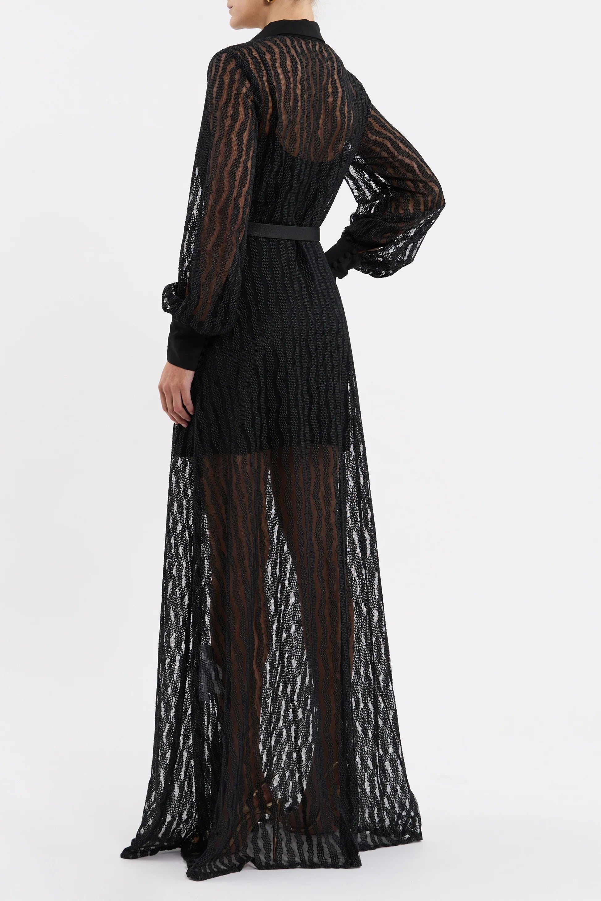 Black lace dress with sheer overlay on a white background