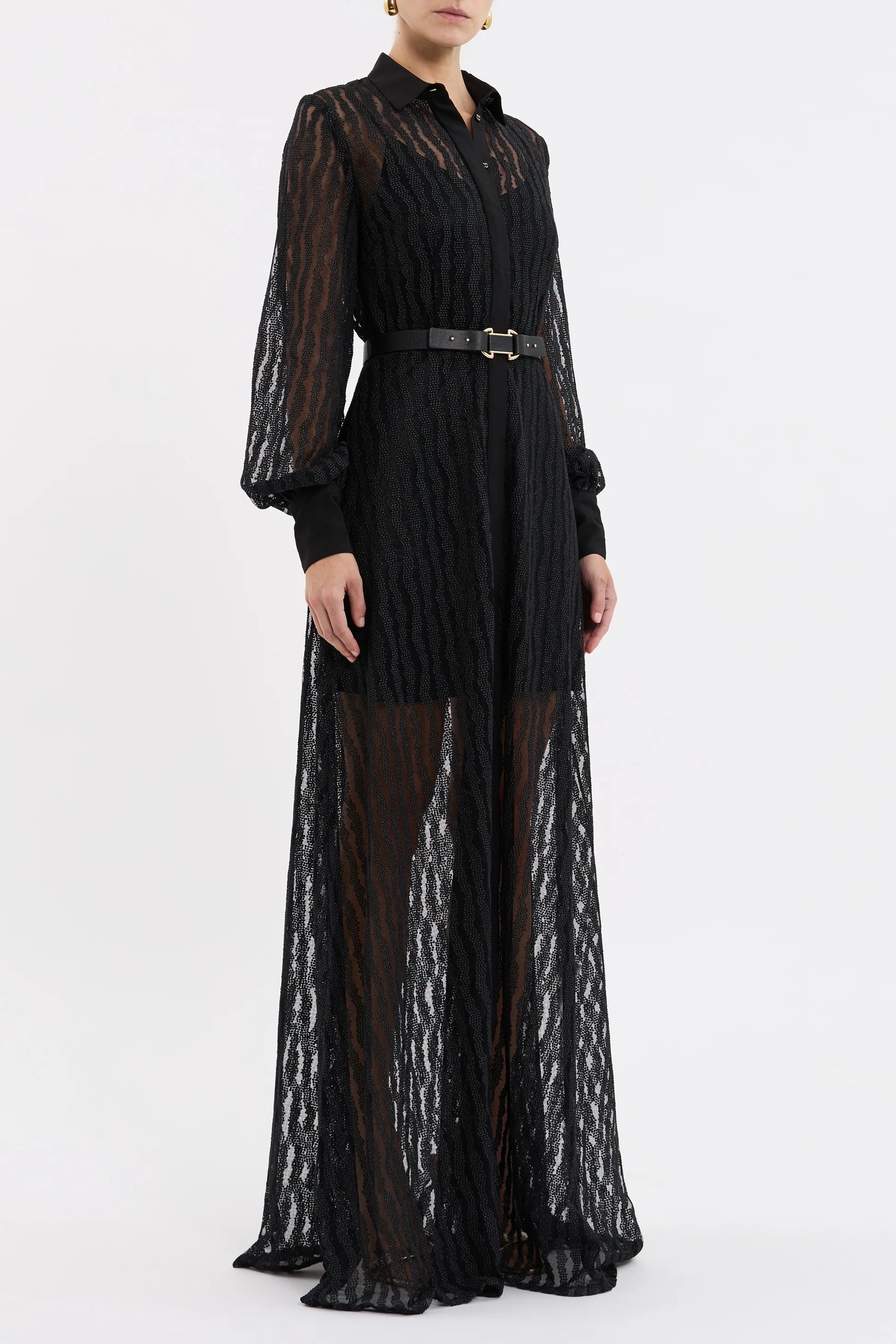 Black lace dress with sheer overlay on a white background