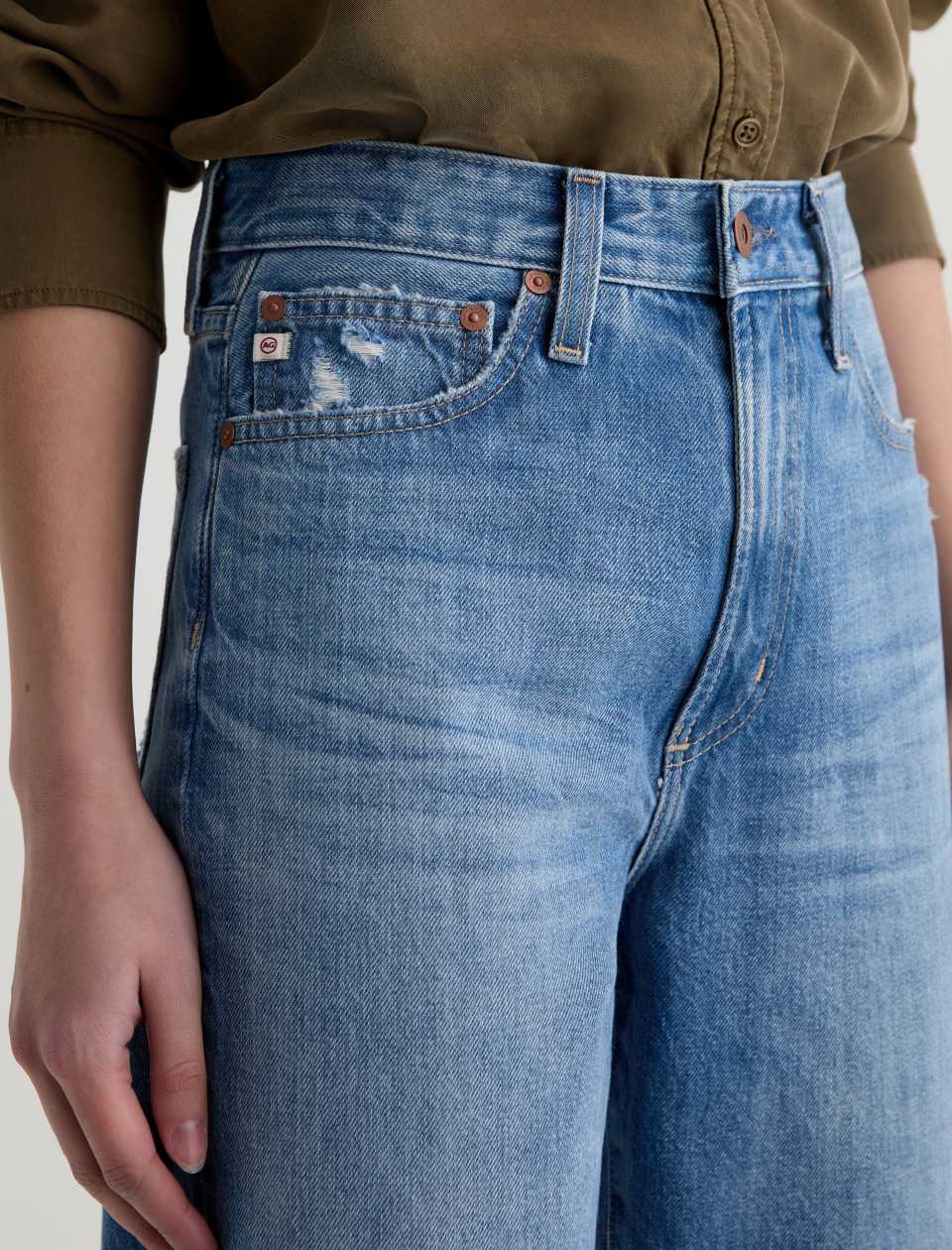 Close-up of blue jeans with a plain background