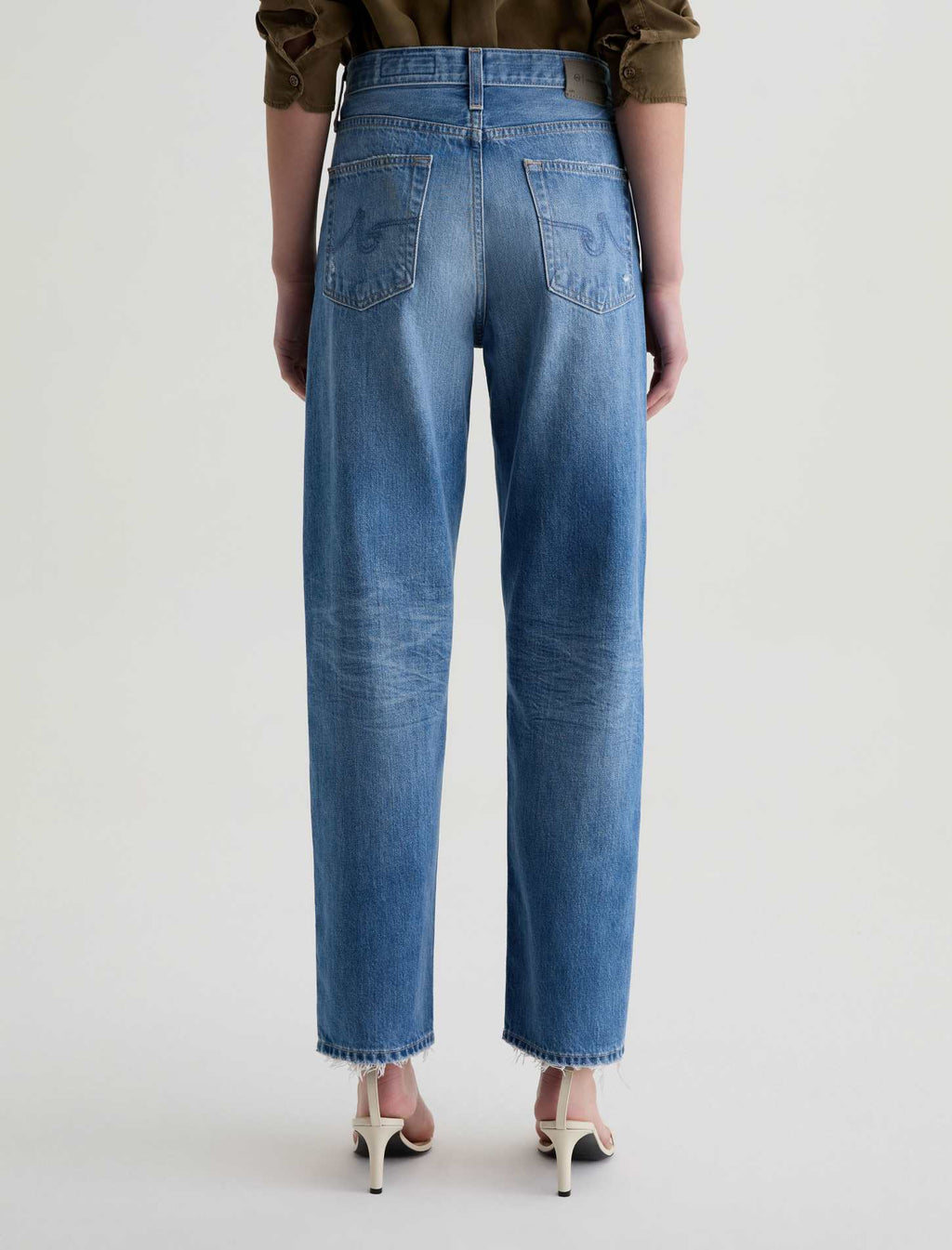 Person wearing blue jeans on a white background