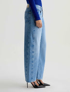 Light blue jeans worn by a person on a white background