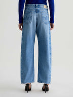 Person wearing blue jeans on a white background