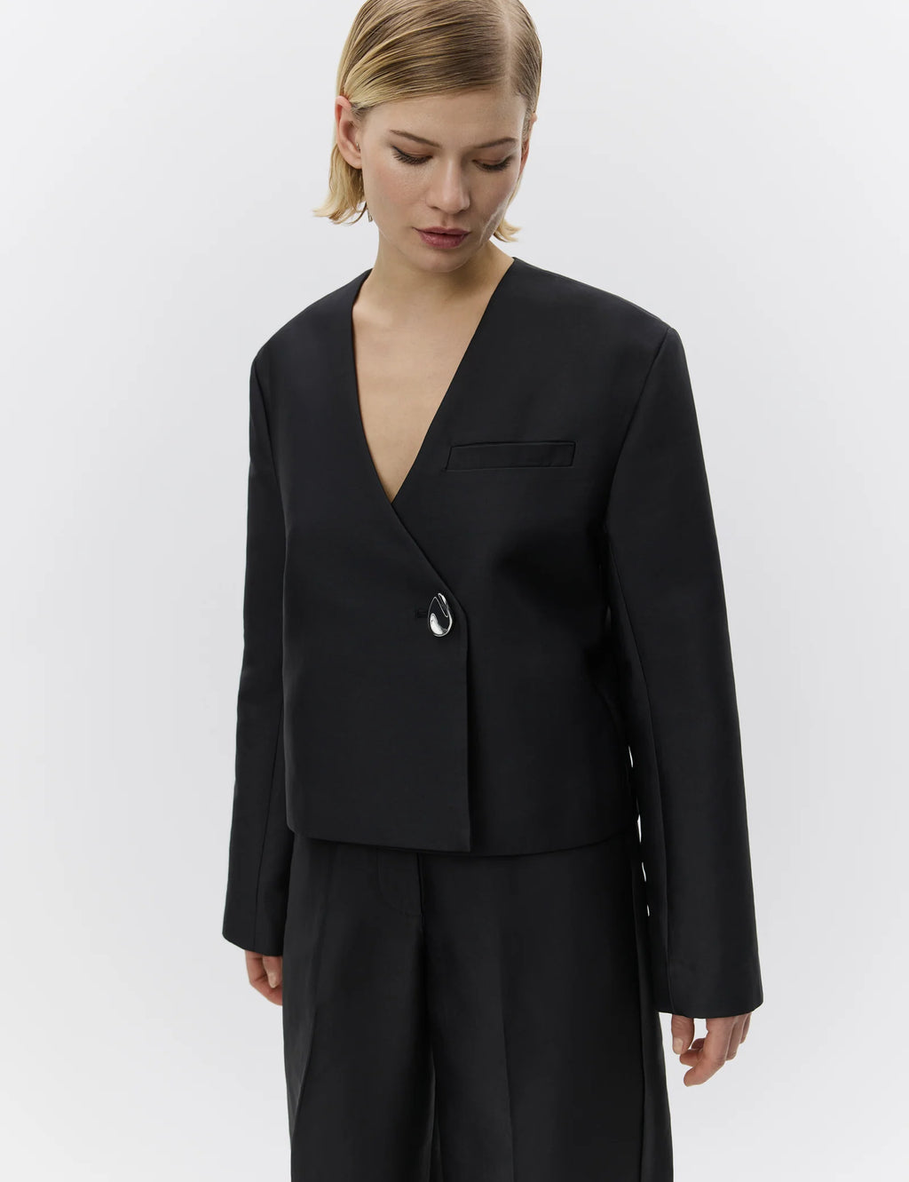 Woman wearing a black suit on a white background