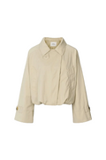 A cropped beige trench jacket with a pointed collar, long sleeves, and button details on the cuffs, shown against a plain white background.
