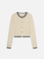 Beige cardigan with black trim on a white background