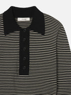Black and white striped shirt with a collar on a light gray background