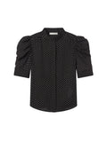 Black blouse with white polka dots on a light gray background. Gillian Top Blouse Frame brand