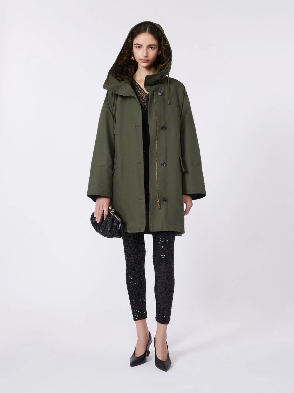 Woman wearing a green coat on a white background