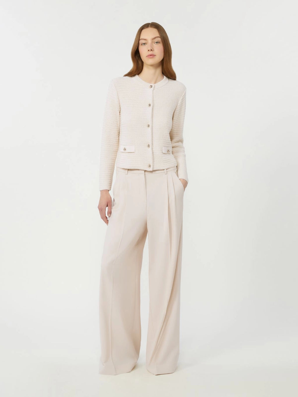 Woman wearing a beige suit on a white background