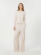 Woman wearing a beige suit on a white background