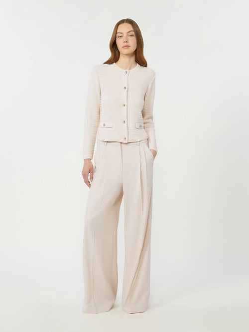 Woman wearing a beige suit on a white background