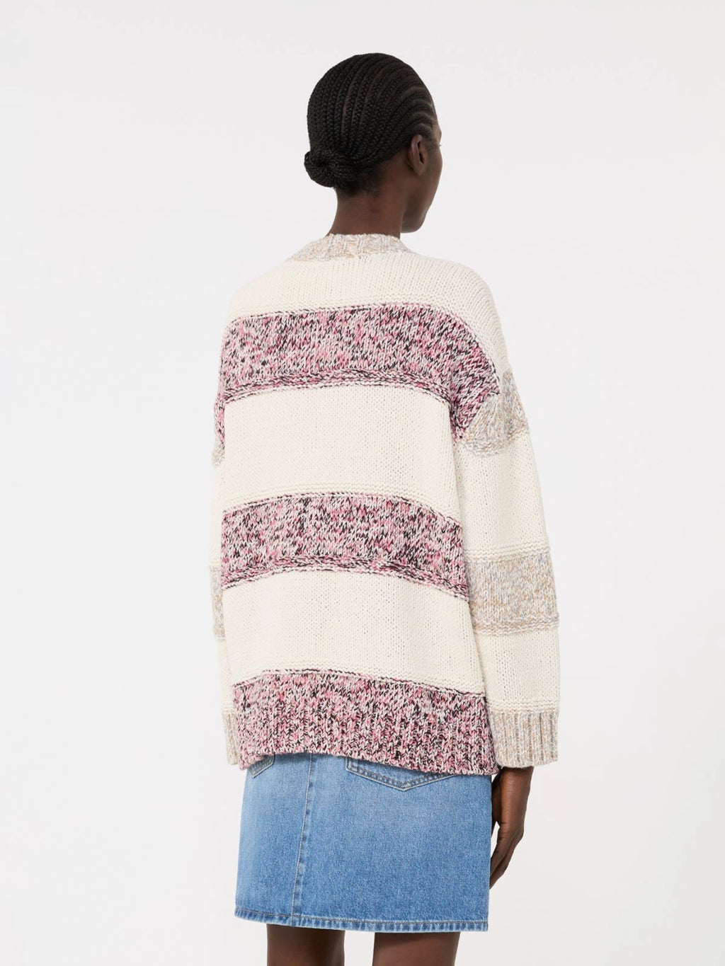 Person wearing a patterned sweater with a white background