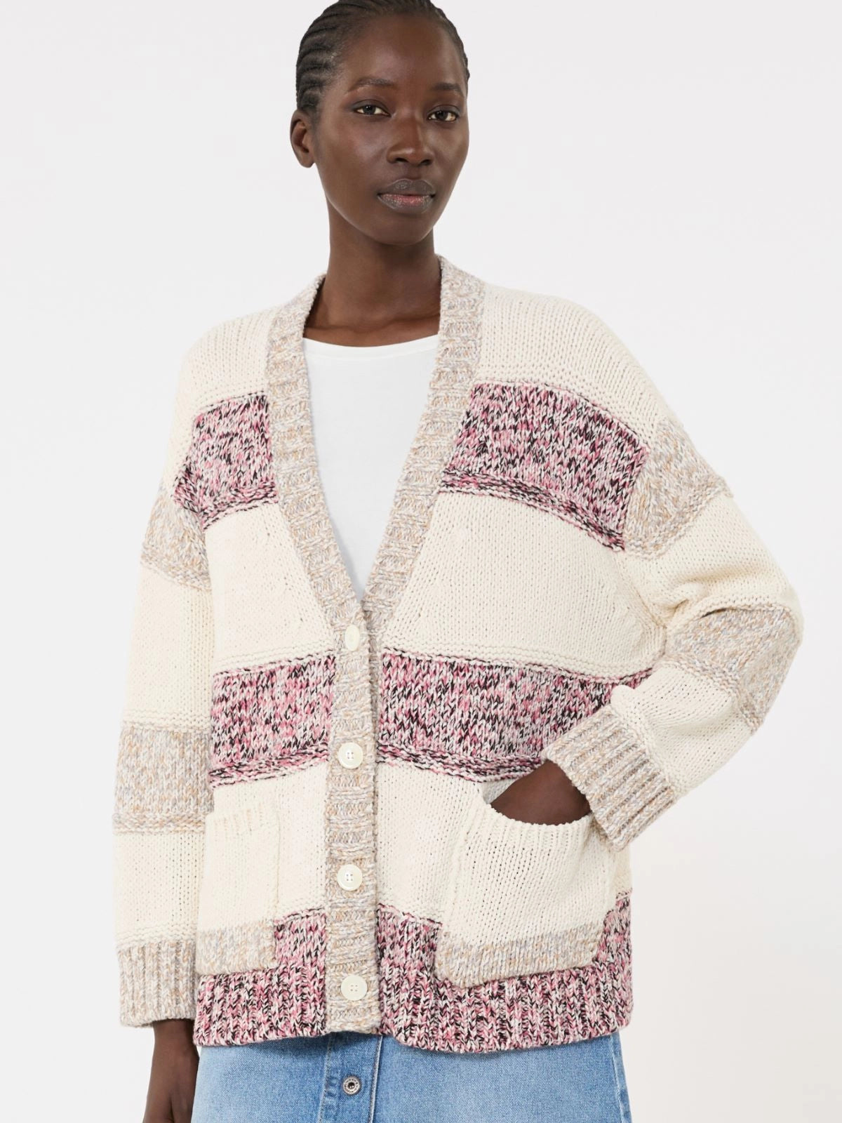 Woman wearing a patterned cardigan with a white background