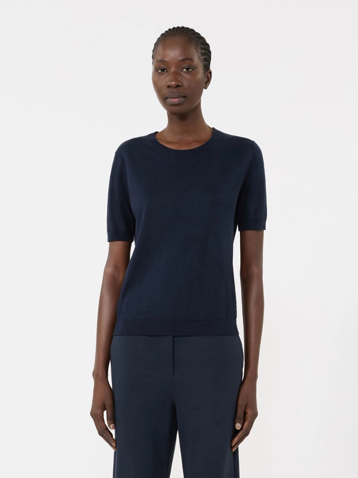 Person wearing a navy blue outfit on a white background