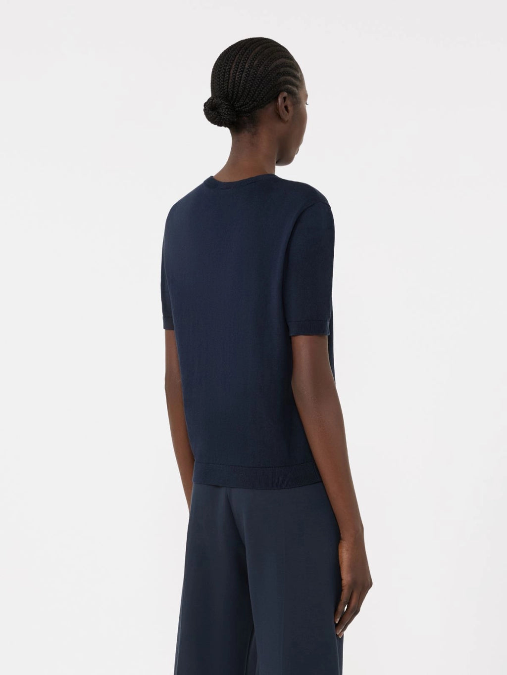 Person wearing a navy blue outfit on a white background