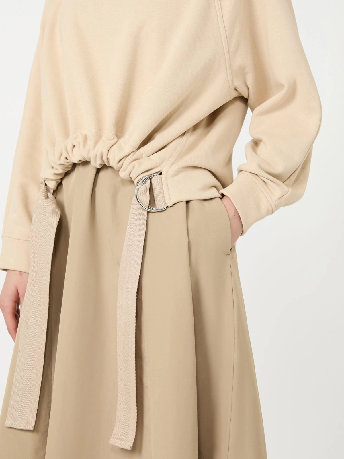 Beige trench coat with a belt on a white background