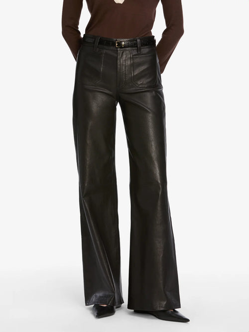 Person wearing black leather pants on a white background