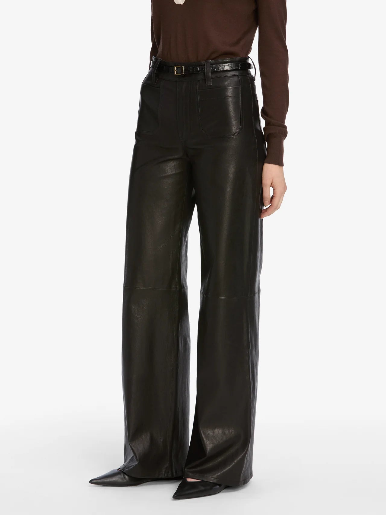 Person wearing black leather pants on a white background