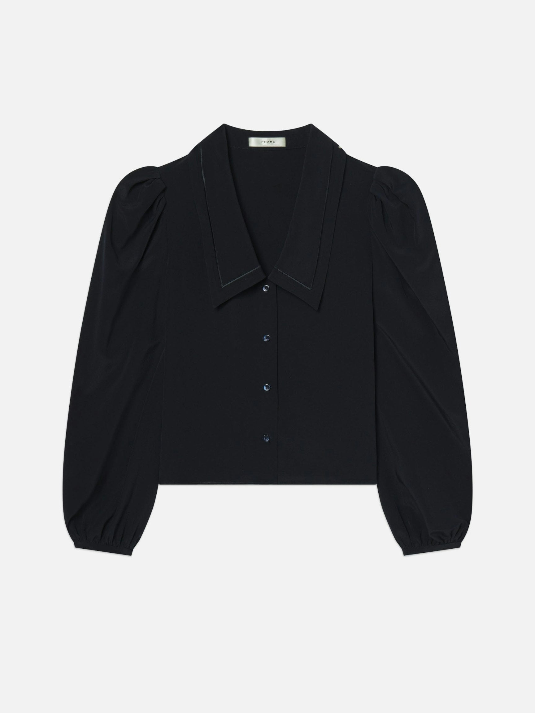 dark navy sailor blouse by frame with puff sleeves on a light gray background
