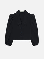 dark navy sailor blouse by frame with puff sleeves on a light gray background