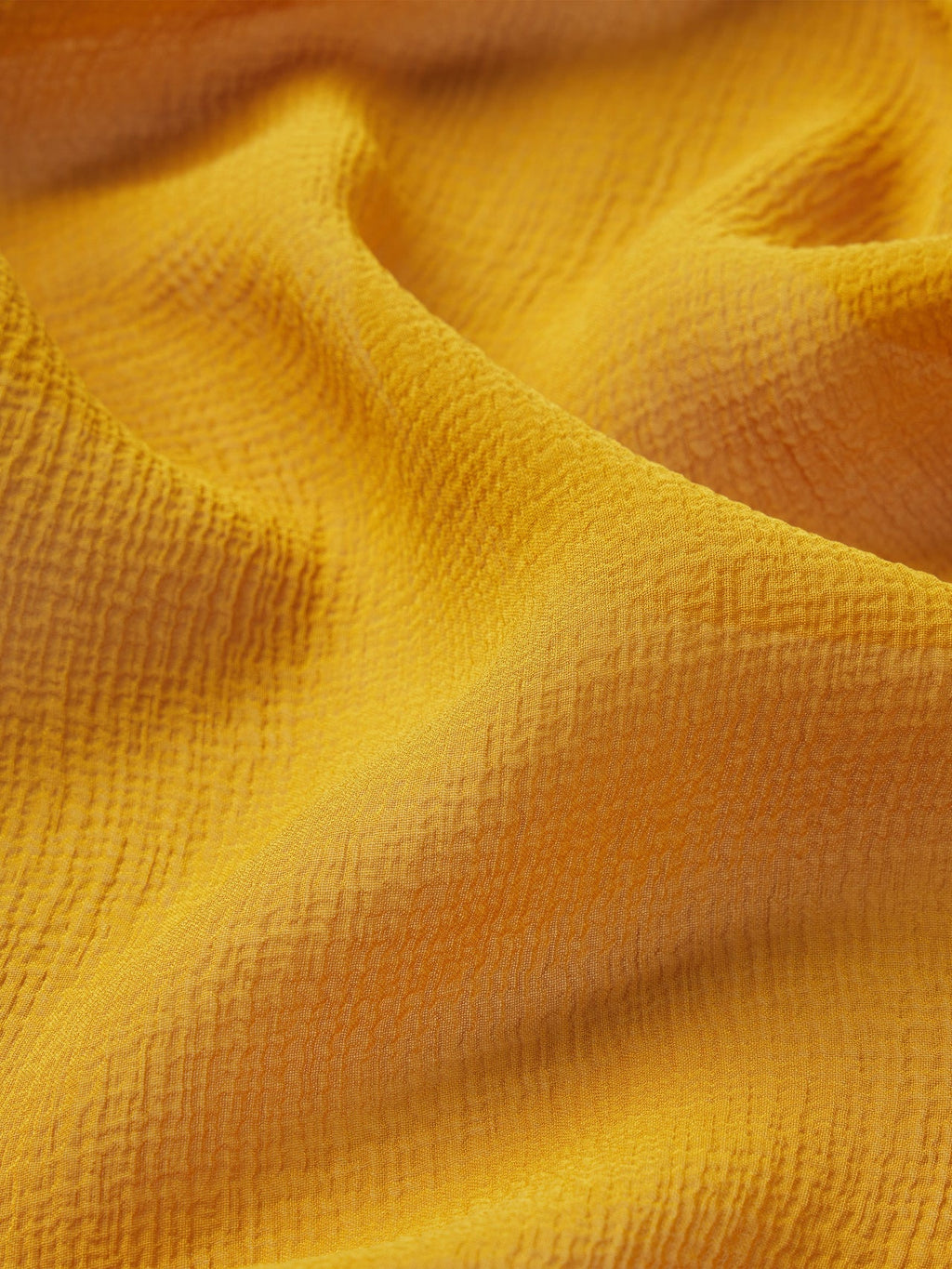 Close-up of textured yellow fabric