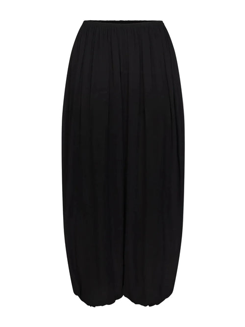A black pleated midi skirt with a wide leg silhouette and elastic waistband, shown against a plain light gray background.