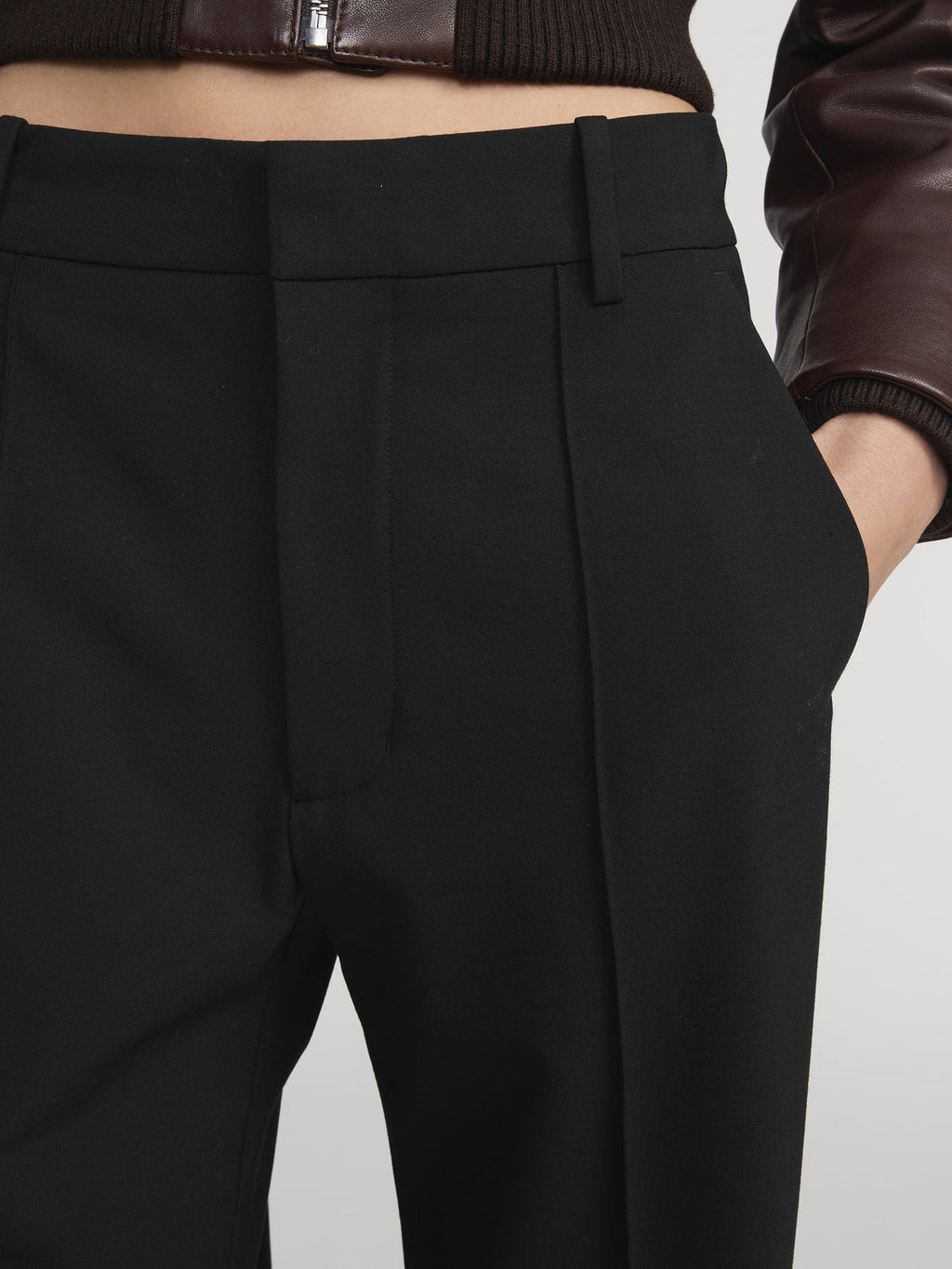 Close-up of black pants on a plain background