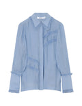 Light blue blouse with ruffled collar on a white background