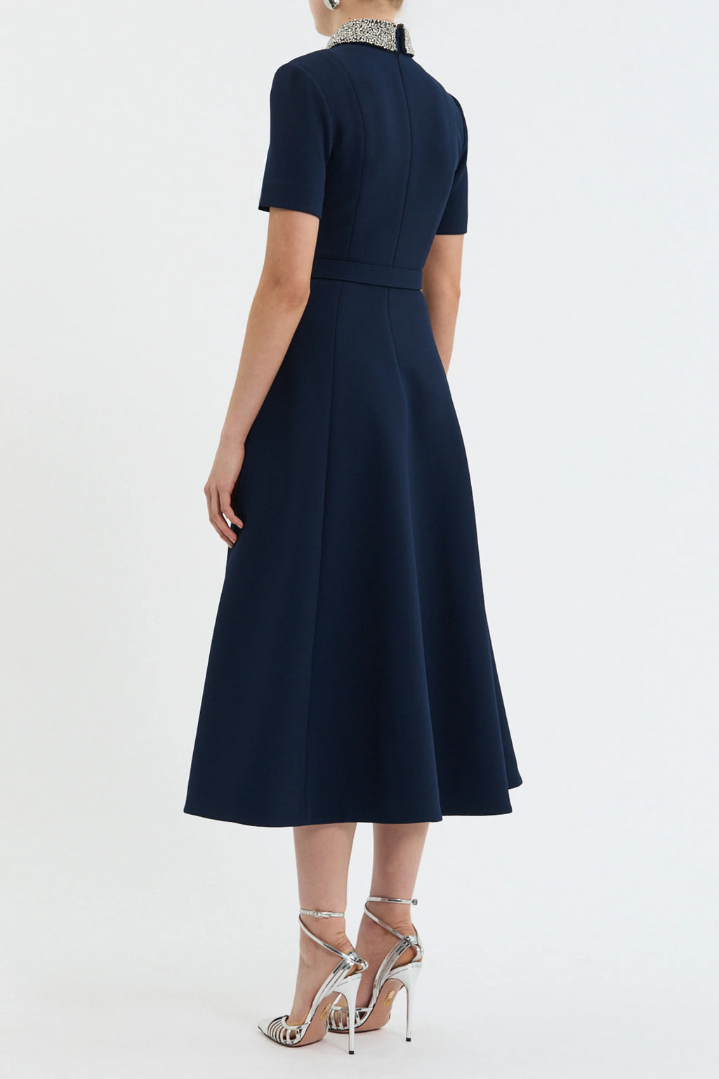 Navy blue dress worn by a model on a white background