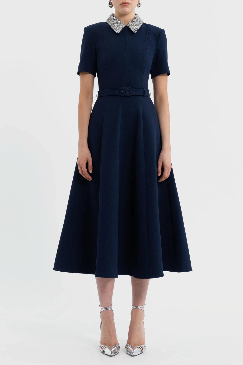 Navy blue dress with a white collar on a white background