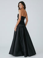 Woman wearing a black evening gown with a white background