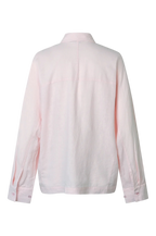 A light pink long-sleeve linen shirt shown from the back, featuring a collar, a vertical center back seam, and a single chest pocket, photographed against a solid white background.