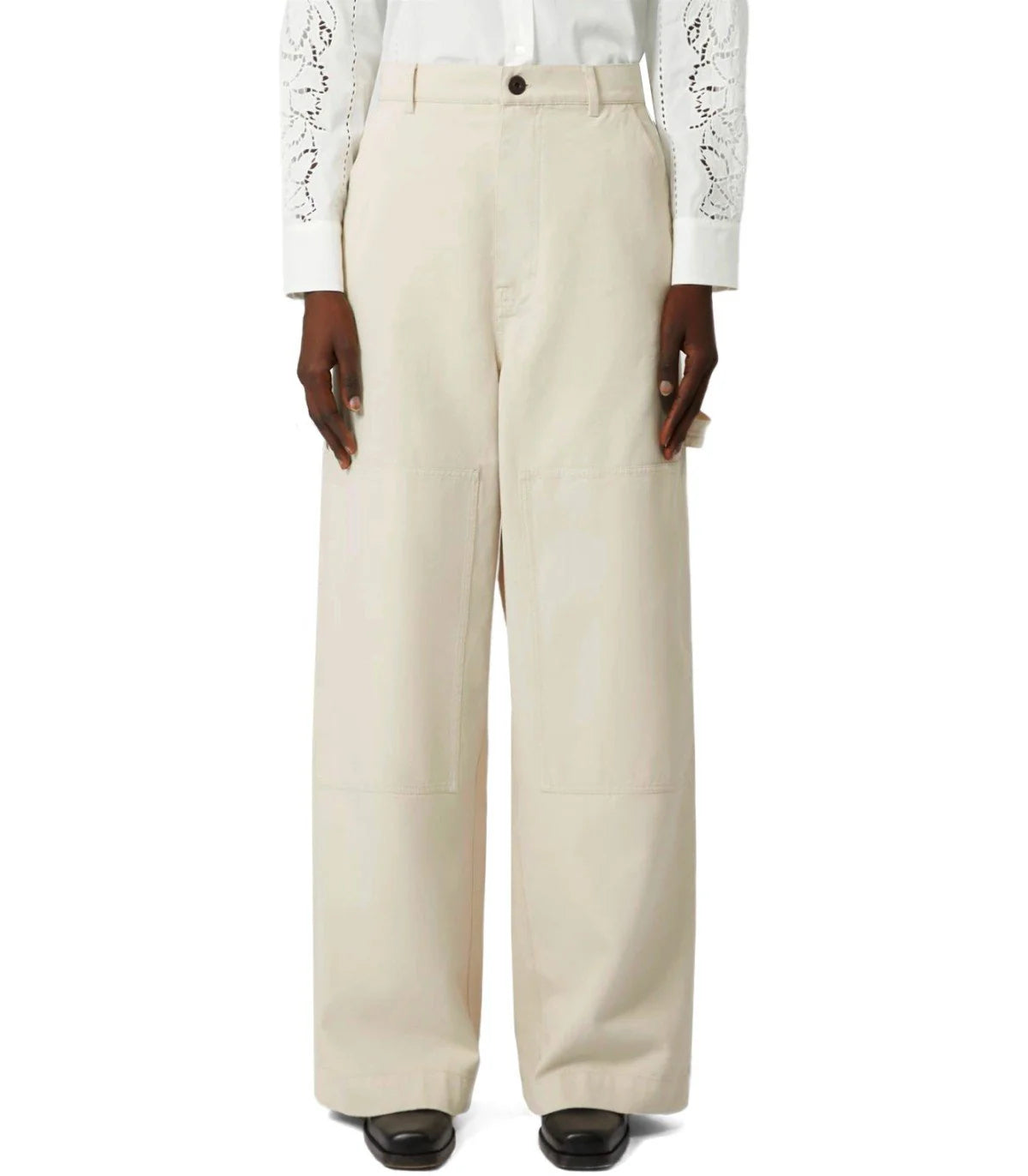 Beige wide-leg pants worn by a person on a white background
