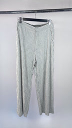 Striped pants hanging on a rack against a white background