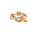 Gold chain ring on a light beige background