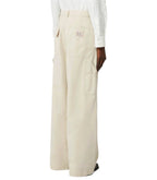 Beige wide-leg pants worn by a person on a white background