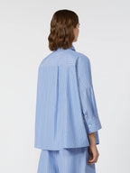 Person wearing a blue striped shirt and pants on a white background